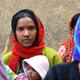 A young mother in the village of Jamkani listens to community workers talk about maternal health and nutrition.